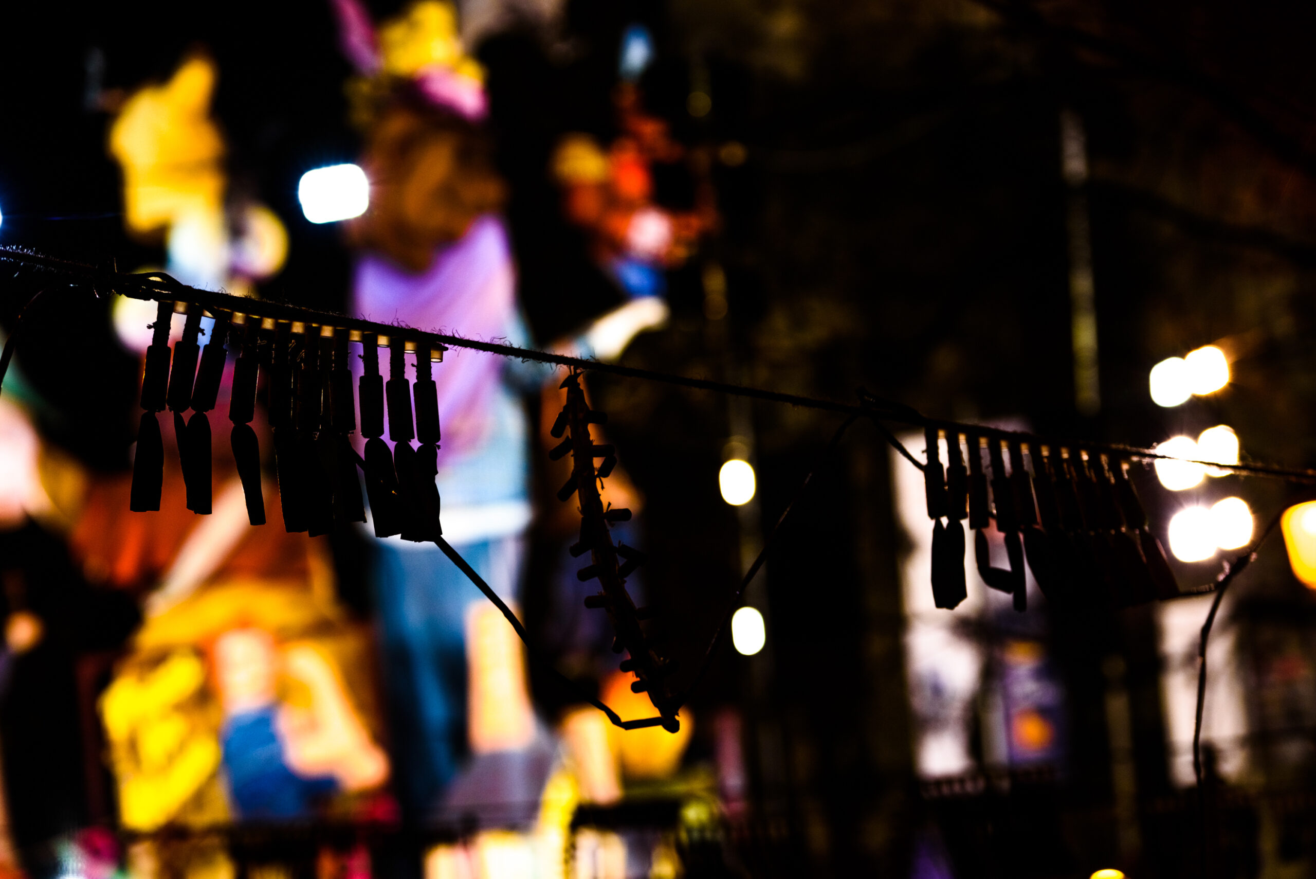 Silhouette of fallas firecrackers of a mascleta in Valencia.